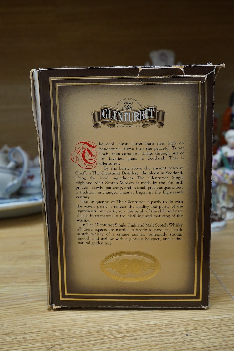 A boxed bottle of Glenturret single highland malt whisky, housed in a globe decanter